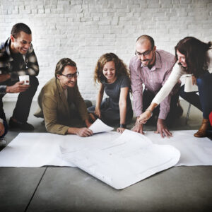 Employees work together on floor of office.