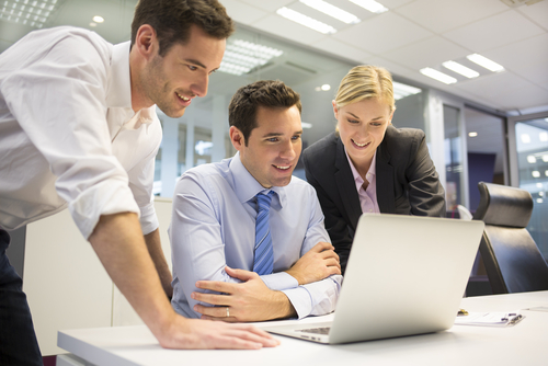 A business team of three in office and planning work